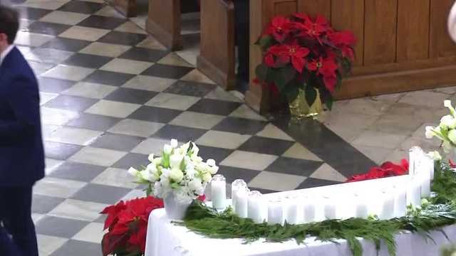 Remember their names: Victims honored with candles on alter