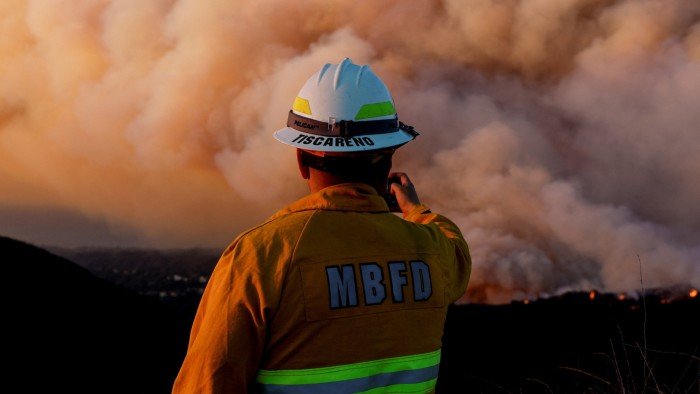 Fires threaten more neighbourhoods as LA braces for high winds